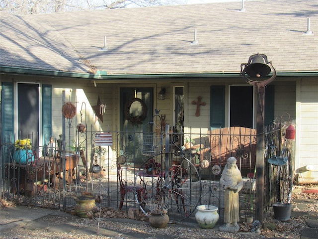 property entrance featuring roof with shingles