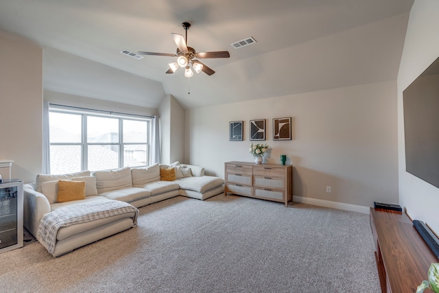 living room featuring lofted ceiling, carpet floors, visible vents, and baseboards