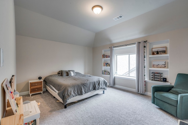 bedroom with lofted ceiling, carpet floors, baseboards, and visible vents