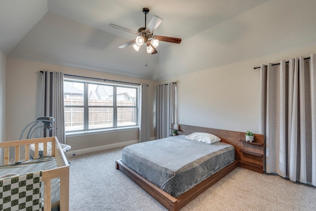 bedroom featuring vaulted ceiling, light carpet, a ceiling fan, and baseboards