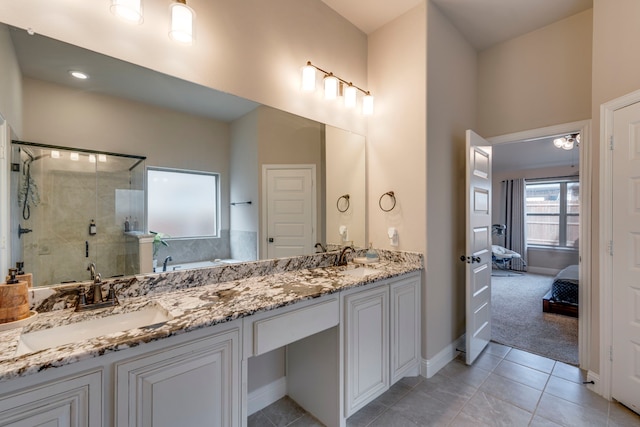 full bathroom featuring double vanity, a stall shower, tile patterned floors, ensuite bathroom, and a sink