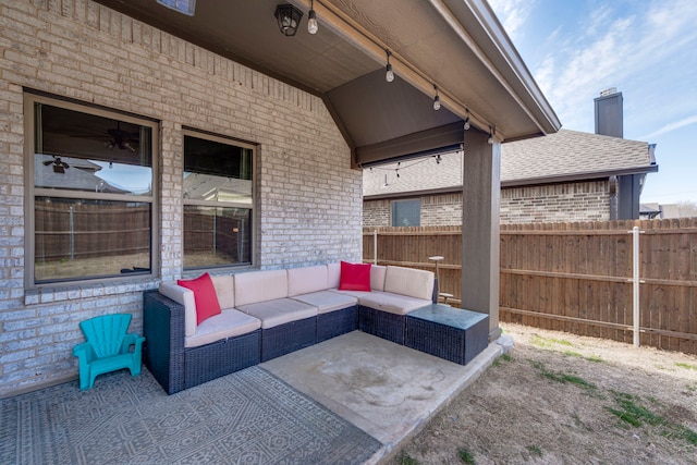 view of patio featuring outdoor lounge area and fence