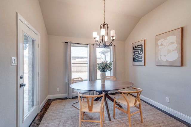 dining area featuring lofted ceiling, a notable chandelier, and baseboards