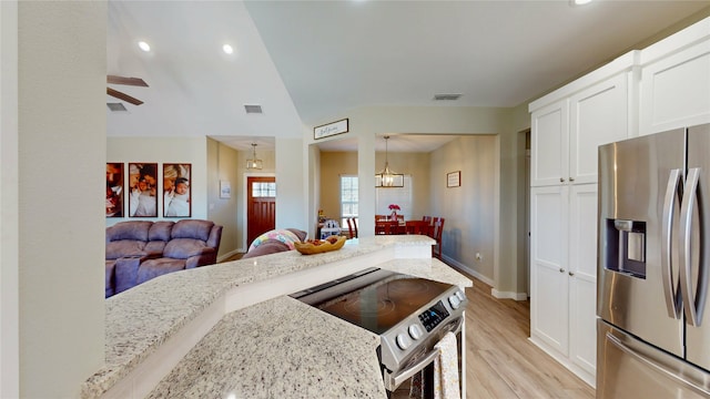 kitchen with visible vents, white cabinets, appliances with stainless steel finishes, light stone counters, and light wood-style floors