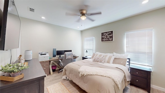 bedroom with a ceiling fan, recessed lighting, visible vents, and light wood-style floors