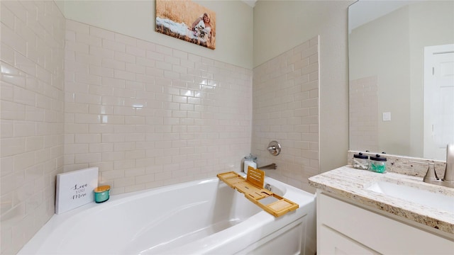 bathroom with a garden tub and vanity