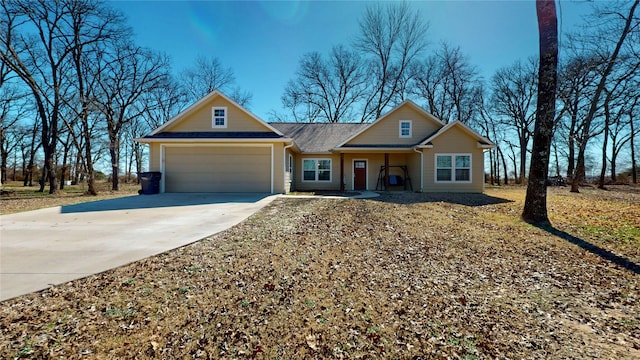 view of front of house featuring concrete driveway and an attached garage