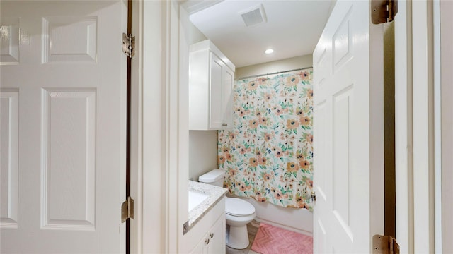 full bath featuring shower / bath combination with curtain, visible vents, vanity, and toilet