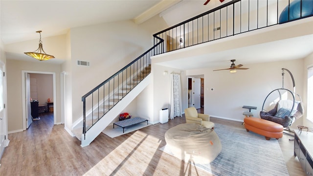 interior space featuring stairway, wood finished floors, visible vents, and a ceiling fan