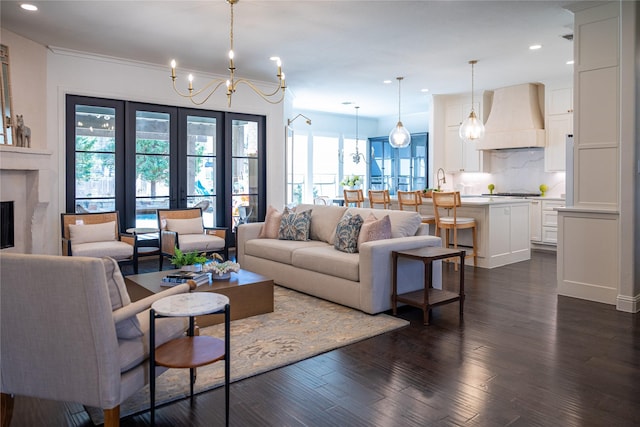 living area with a chandelier, a premium fireplace, dark wood-style floors, and recessed lighting