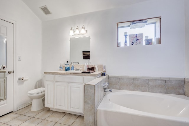 bathroom featuring visible vents, toilet, vanity, tile patterned flooring, and a bath