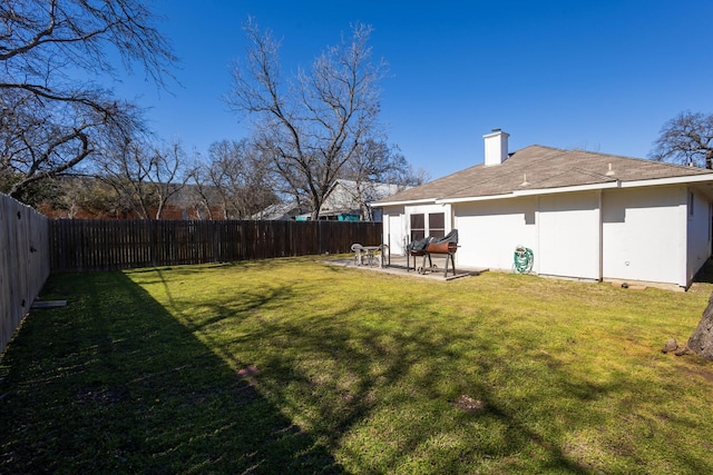 view of yard with a fenced backyard and a patio