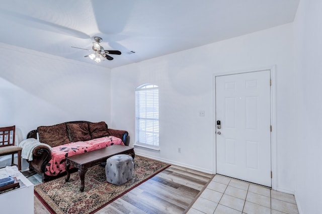 living area with light wood-style flooring, visible vents, and a ceiling fan