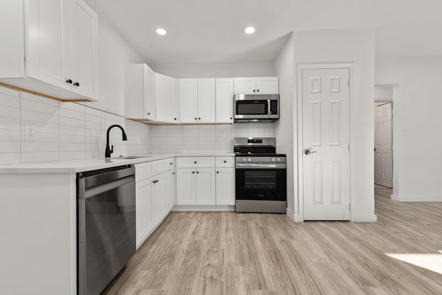 1020 Orange St, Fort Worth, TX 76110 - kitchen featuring light wood-style flooring, a sink, stainless steel appliances, and light countertops