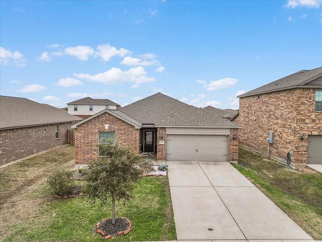 view of front of home featuring driveway, a garage, a shingled roof, a front lawn, and brick siding