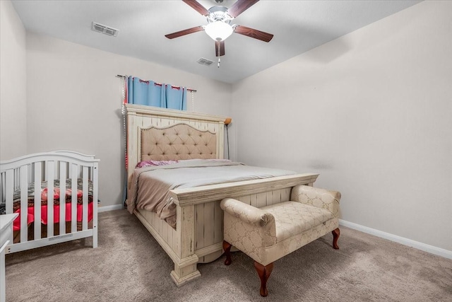 bedroom with carpet, visible vents, and baseboards