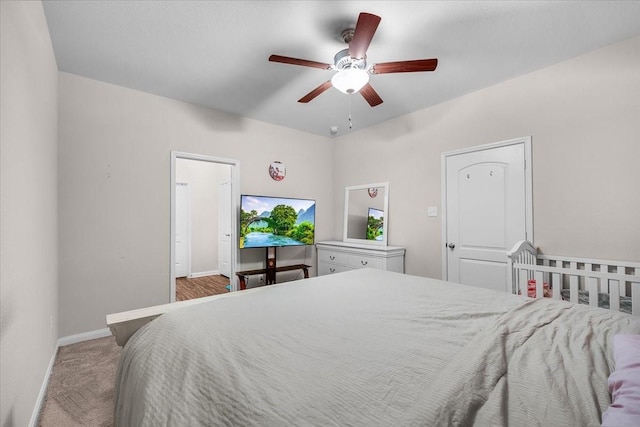 bedroom with ceiling fan, carpet flooring, and baseboards