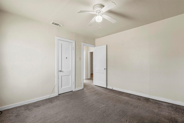 unfurnished bedroom featuring baseboards, visible vents, and dark colored carpet