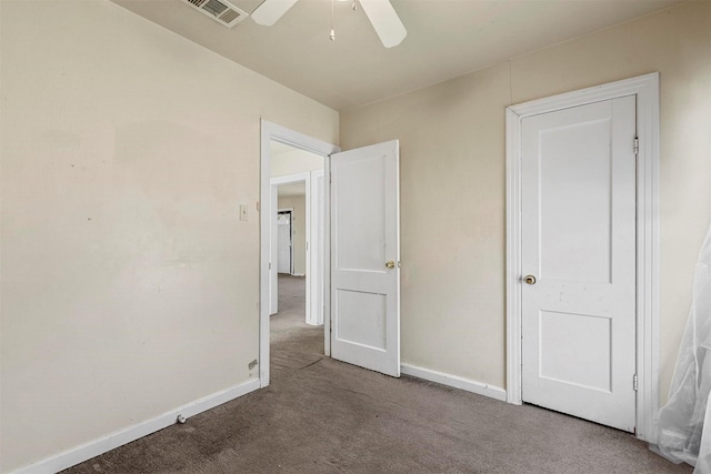 unfurnished bedroom with carpet, visible vents, ceiling fan, and baseboards