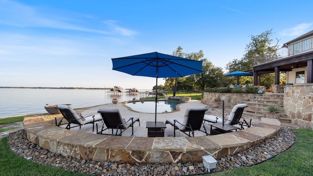 view of patio / terrace with a water view and an outdoor pool