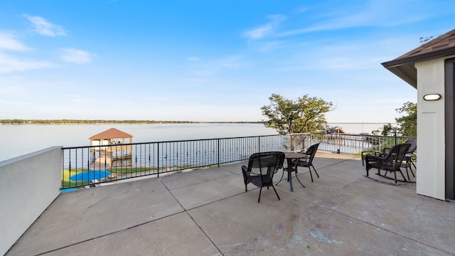 view of patio / terrace with a water view and a playground