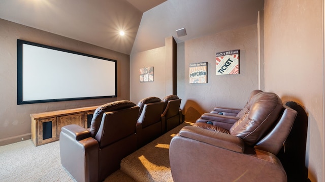 carpeted home theater featuring vaulted ceiling, visible vents, and baseboards