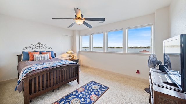 carpeted bedroom with a ceiling fan, visible vents, and baseboards