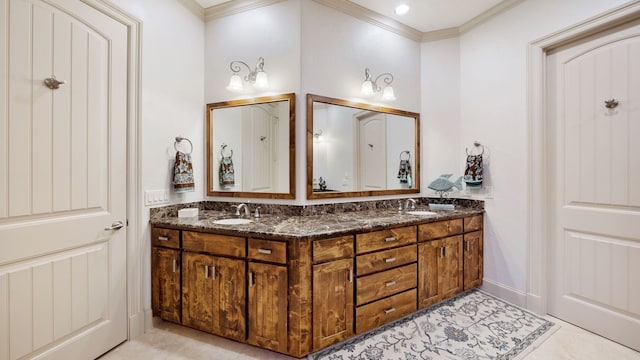 bathroom with double vanity, crown molding, and a sink