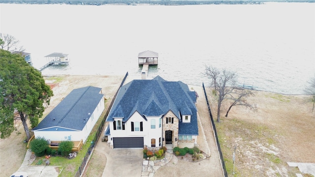 birds eye view of property with a water view