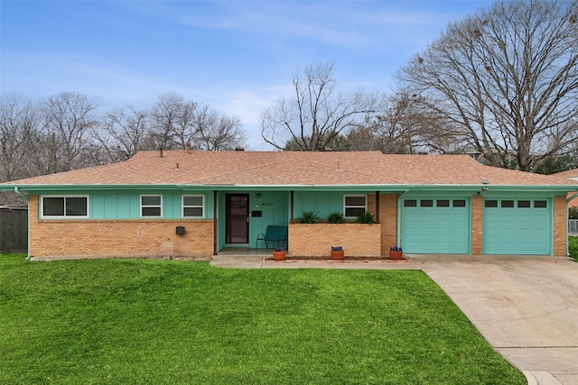 ranch-style home with driveway, an attached garage, a front lawn, and brick siding