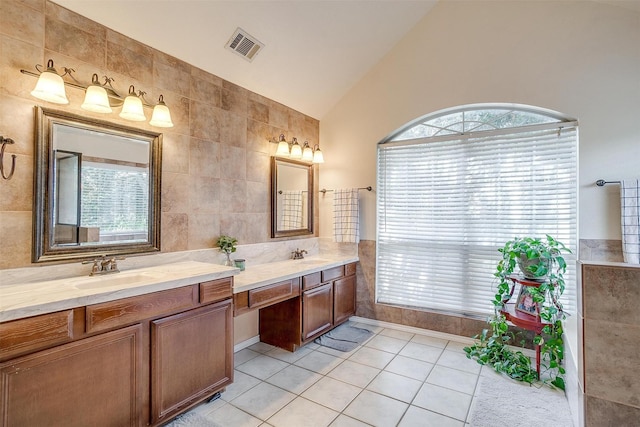 bathroom with tile walls, double vanity, visible vents, a sink, and tile patterned flooring