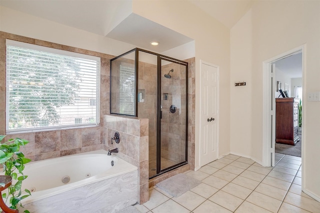 bathroom featuring tile patterned flooring, a shower stall, and a whirlpool tub