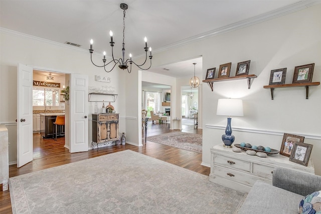 living room with ornamental molding, visible vents, and dark wood finished floors