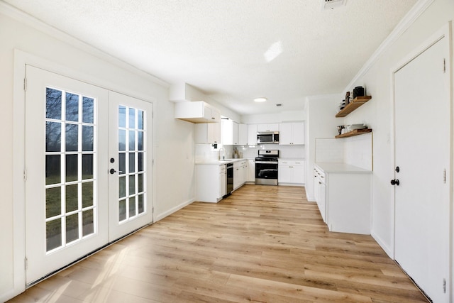 kitchen with french doors, open shelves, stainless steel appliances, light countertops, and white cabinets