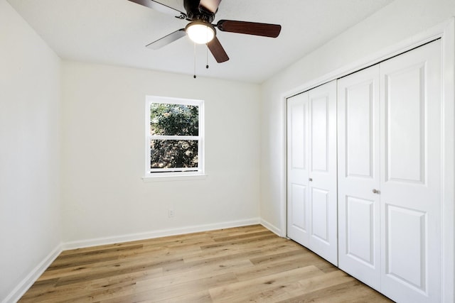 unfurnished bedroom with light wood-style floors, a closet, ceiling fan, and baseboards