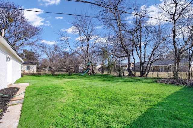 view of yard with a playground and fence private yard