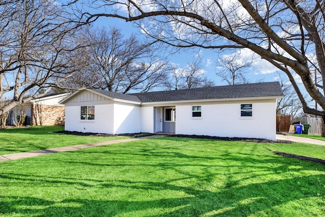 single story home featuring a shingled roof, brick siding, board and batten siding, and a front lawn