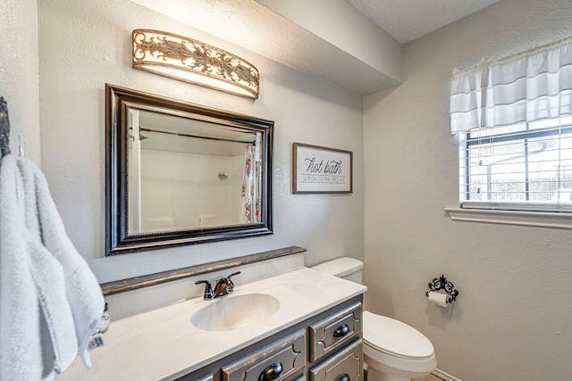 bathroom featuring toilet and vanity