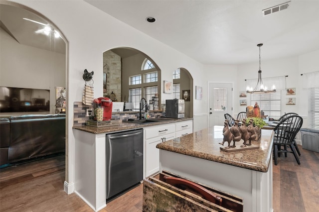 kitchen with decorative light fixtures, visible vents, white cabinetry, dark stone counters, and dishwasher