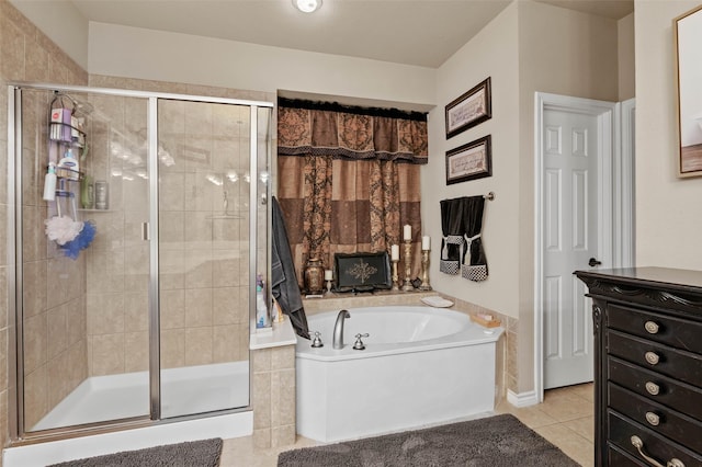 bathroom with a stall shower, tile patterned flooring, and a garden tub