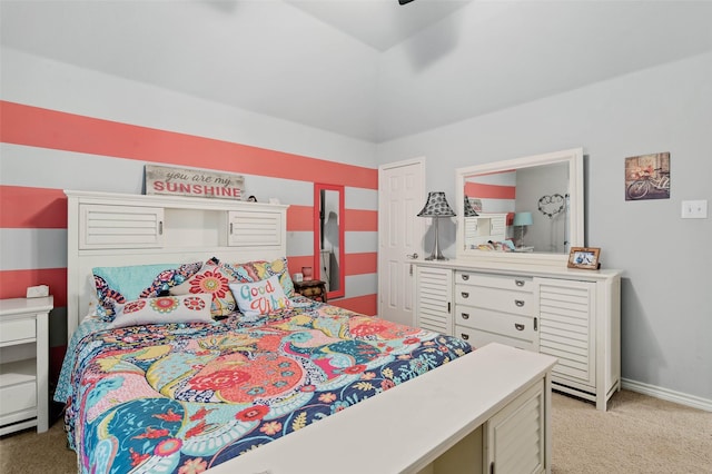 bedroom featuring lofted ceiling, light colored carpet, and baseboards