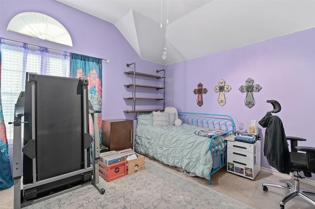 bedroom with vaulted ceiling and light carpet