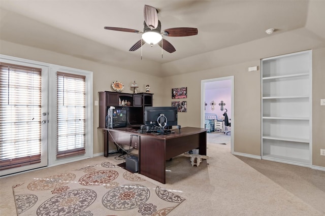 office space with light carpet, built in shelves, baseboards, and french doors