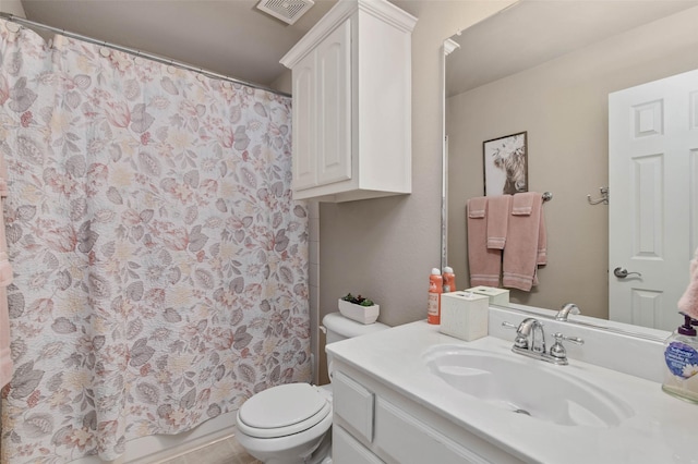 bathroom with toilet, visible vents, and vanity