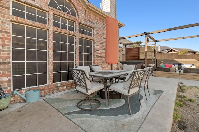 view of patio with outdoor dining area, fence, a hot tub, and a pergola