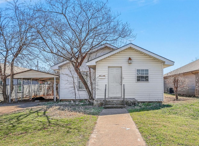 view of front of house with entry steps, central AC unit, and a front lawn