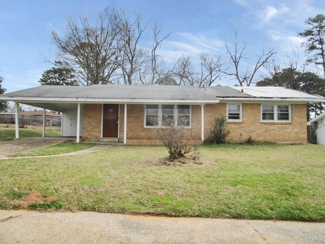 ranch-style home with brick siding, a carport, and a front yard