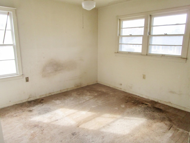 unfurnished room featuring plenty of natural light