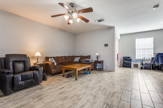 living room with ceiling fan, wood finish floors, and visible vents