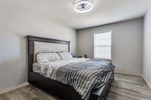 bedroom featuring wood finished floors and baseboards